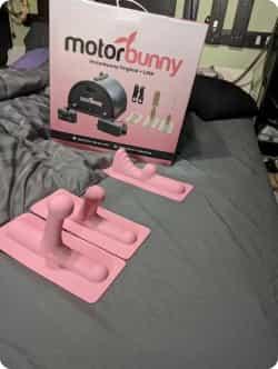 pink motorbunny dildo attachments sitting on bed